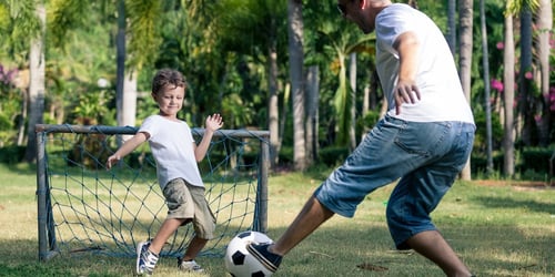 parent-teaching-kid-soccer.jpeg